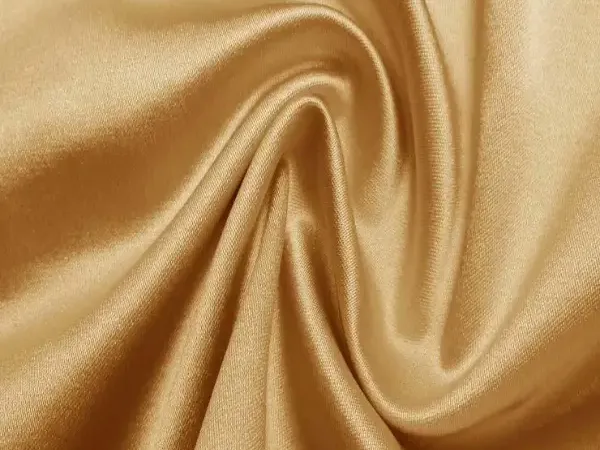 Fluid silk and satin in a champagne gold