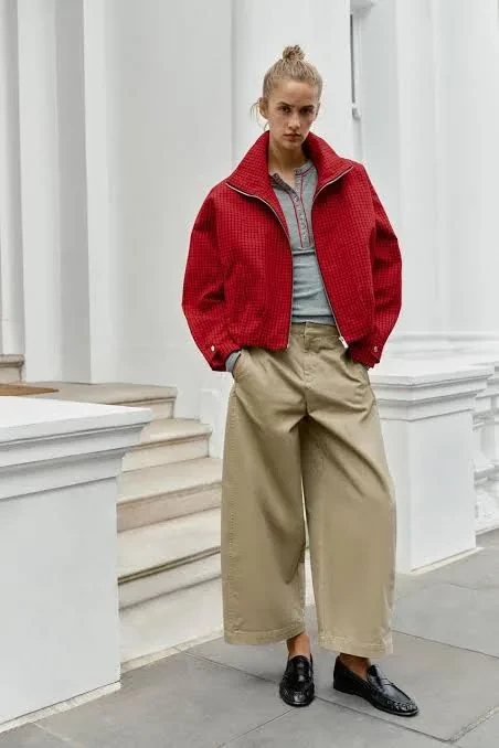 Beige jacket worn by a model — finished production sample, full figure visible