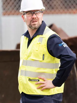 Construction worker in high-visibility safety vest on site