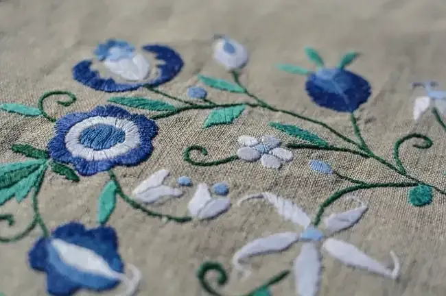 Custom embroidery stitching a floral logo