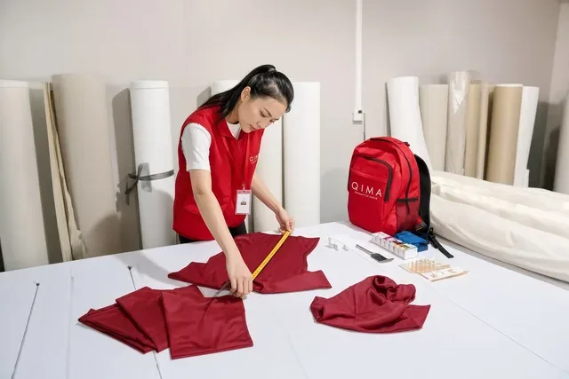 Quality control measuring and inspecting fabric panels at a cut and sew facility