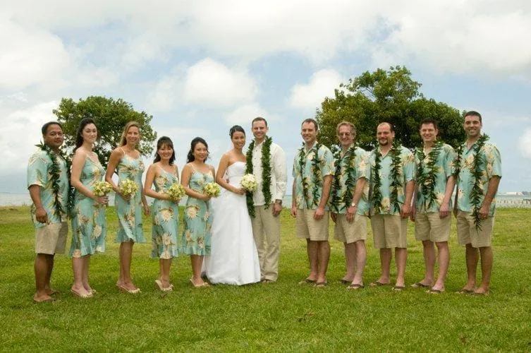 Bridal party guests in soft floral Hawaiian shirts at a welcome dinner