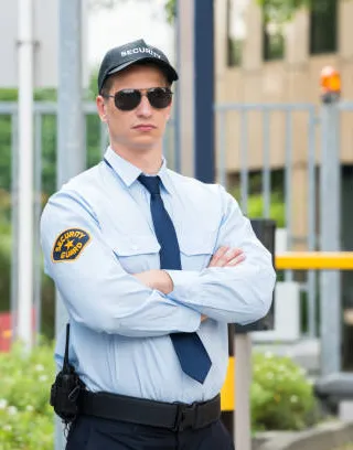 Security guard in professional uniform at entrance