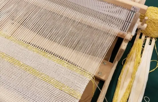 Spinning and weaving — yarn and loom for a custom towel run