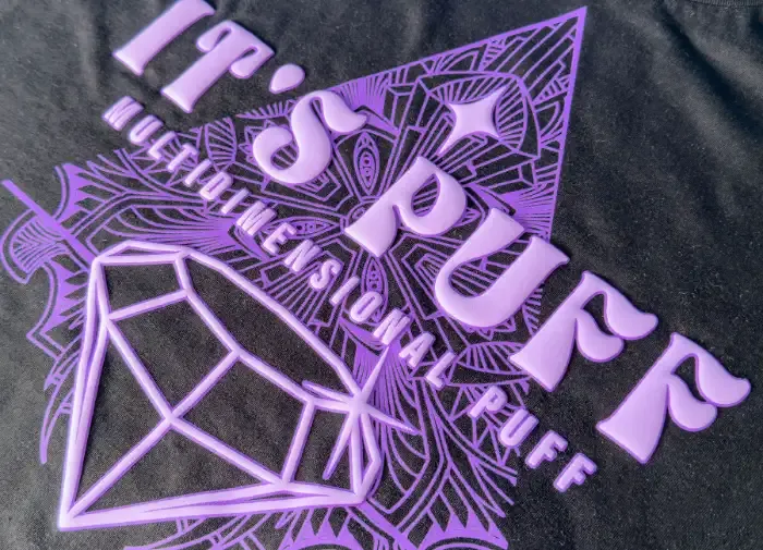 Screen-printed puff finish in bold opaque ink on a black tee