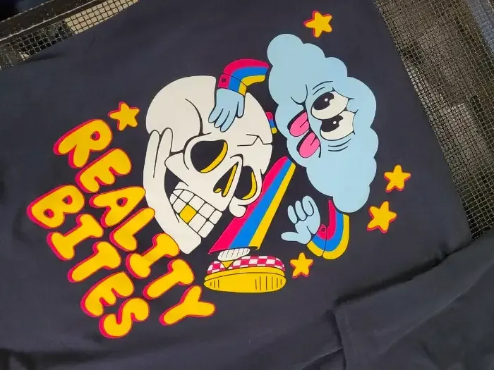 Water-based screen print detail on a colourful tee